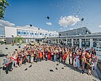 Graduates throw their graduation hats