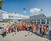 Graduates throw their graduation hats