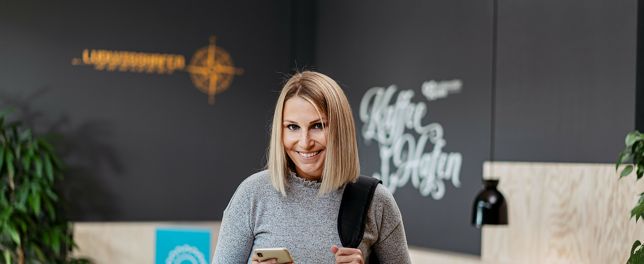 Young woman with cell phone in hand