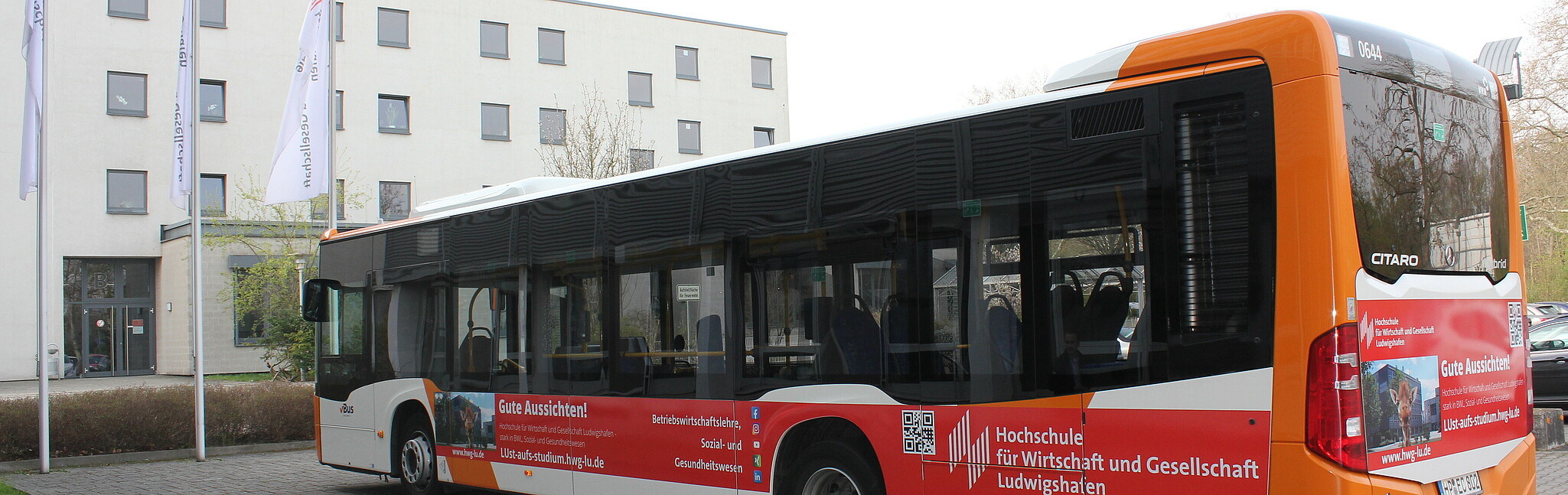 The new "university bus" in the parking lot in front of the B-building