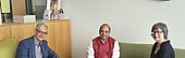 Change_Deputy_Director_OAI-OAI-2026 Three people are sitting on sofas in an office and smiling.