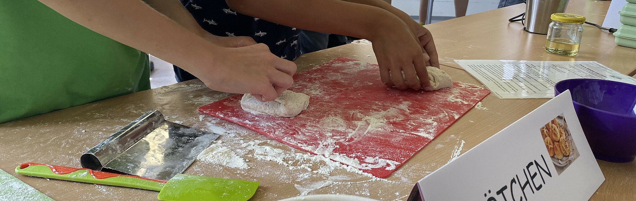 Children's hands knead dough