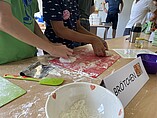 Children's hands knead dough
