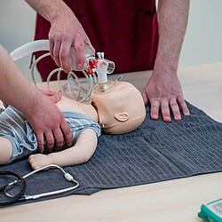 Resuscitation exercise on a child doll.