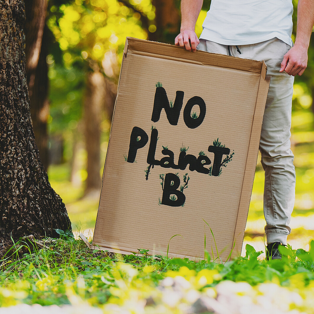 Cardboard sign with the inscription No Planet B against a green background