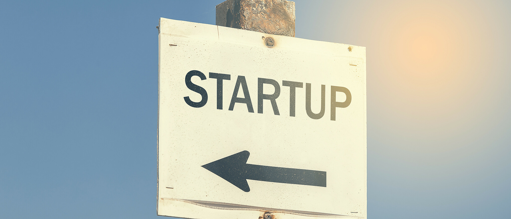 A sign that says "Startup" with an arrow pointing to the left.