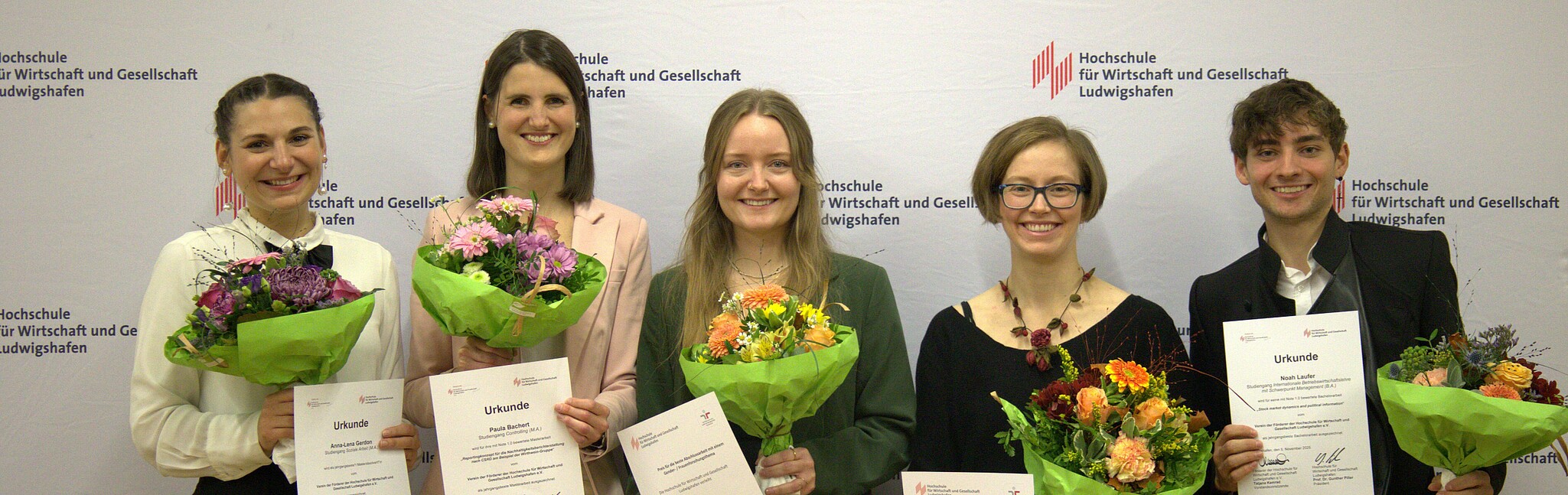 Award winners in front of the photo wall
