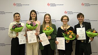 Award winners in front of the photo wall
