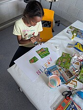 Kinderzukunftsdiplom_Collage_Einzelbild-IBE-2026 Ein dunkelhäutiges Mädchen gestaltet eine Collage zum Thema Ärztin