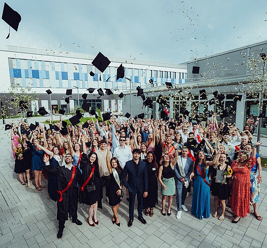 Graduates throwing hats, graduation ceremony July 2024