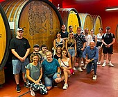 Student group in front of a large wine barrel