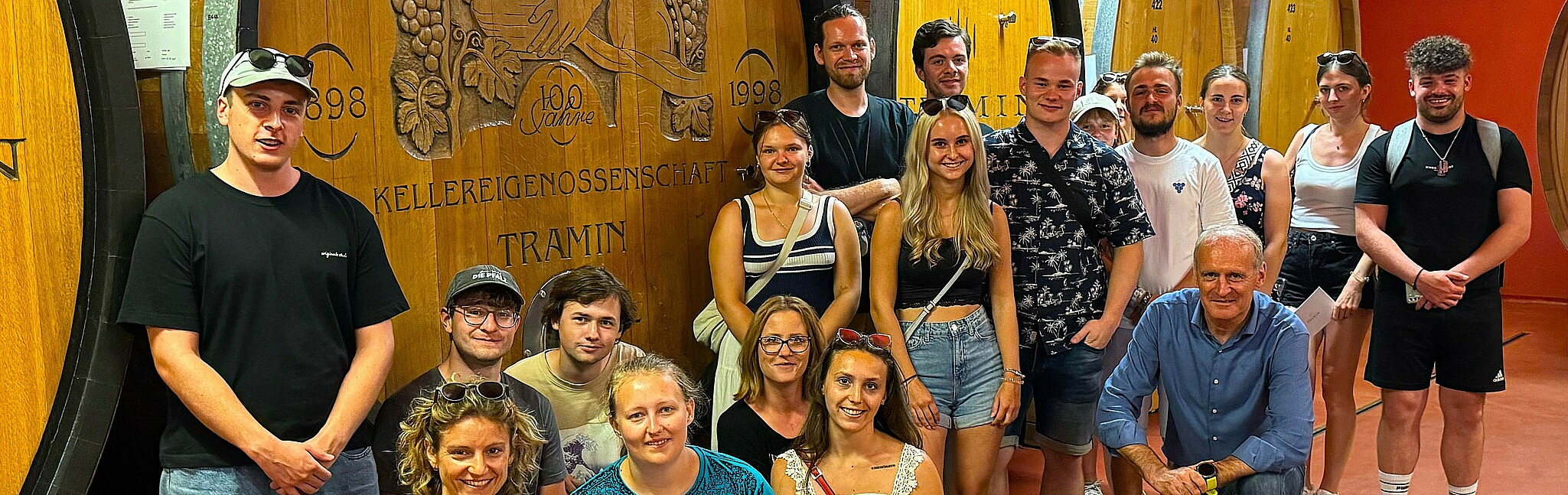 Student group in front of a large wine barrel