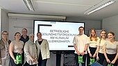 Group of people in front of large presentation screen