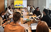 Students with laptops around a table